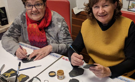Ulrike Spieß (l.) und Regine Knoch aus Saalburg beim Engel auf Schieferstücke malen